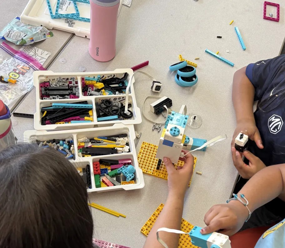 Students building a LEGO Spike robot